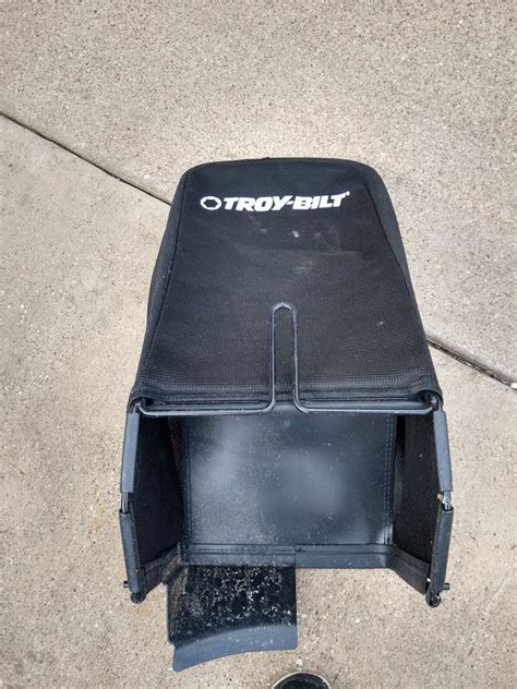 It's built with a rugged 21" steel deck and 11" rear wheels to help easily maneuver on hills and over rough spots. . Grass catcher bag for troy bilt
